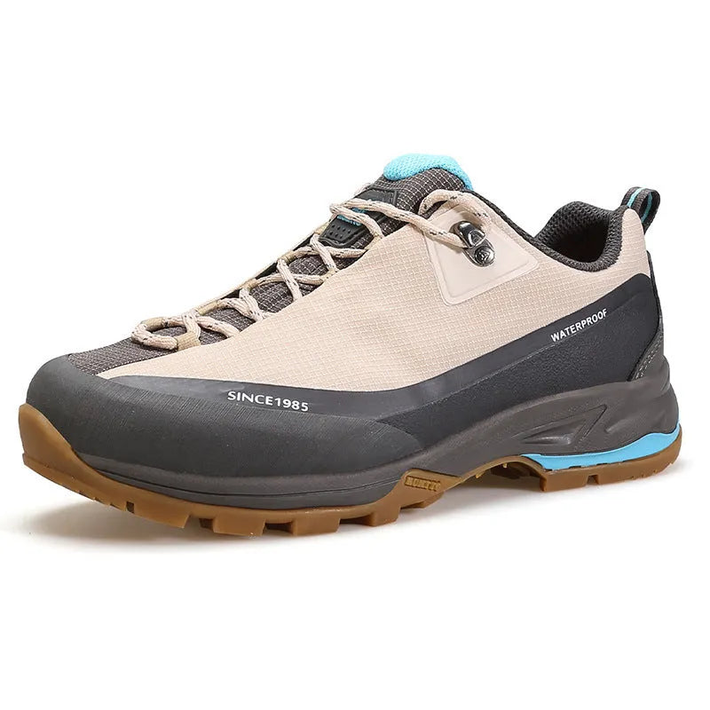 Low-top hiking boots in black with leather mesh upper, rubber outsole, and front lace-up design on a neutral background.