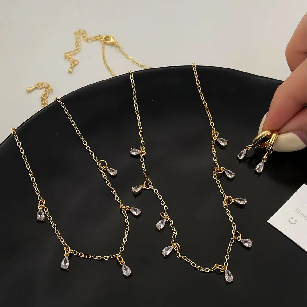 Women's zircon jewellery set showing geometric meteor shower necklace, earrings, and anklet