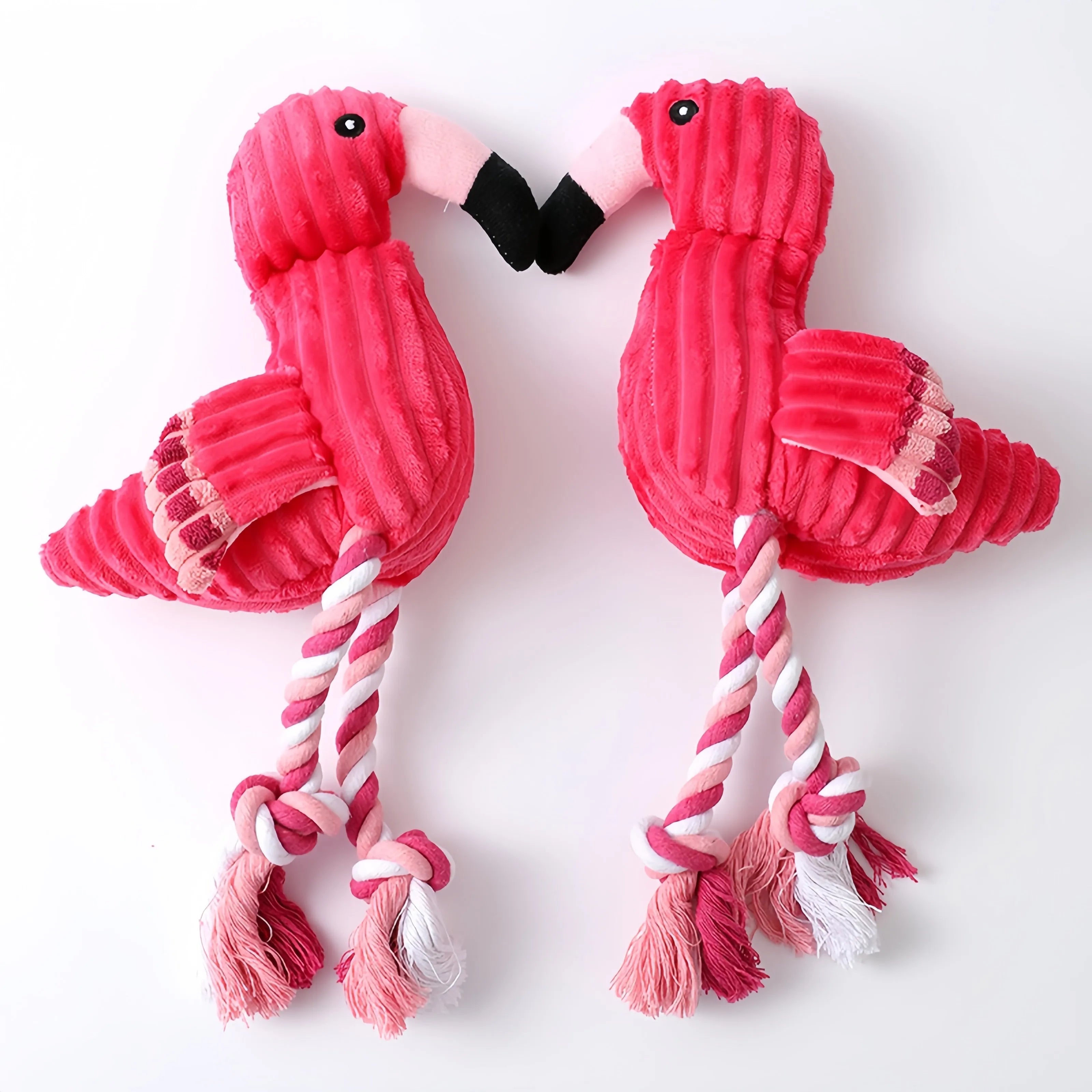 Pink animal-shaped corduroy dog toy with a squeaker inside on a white background.