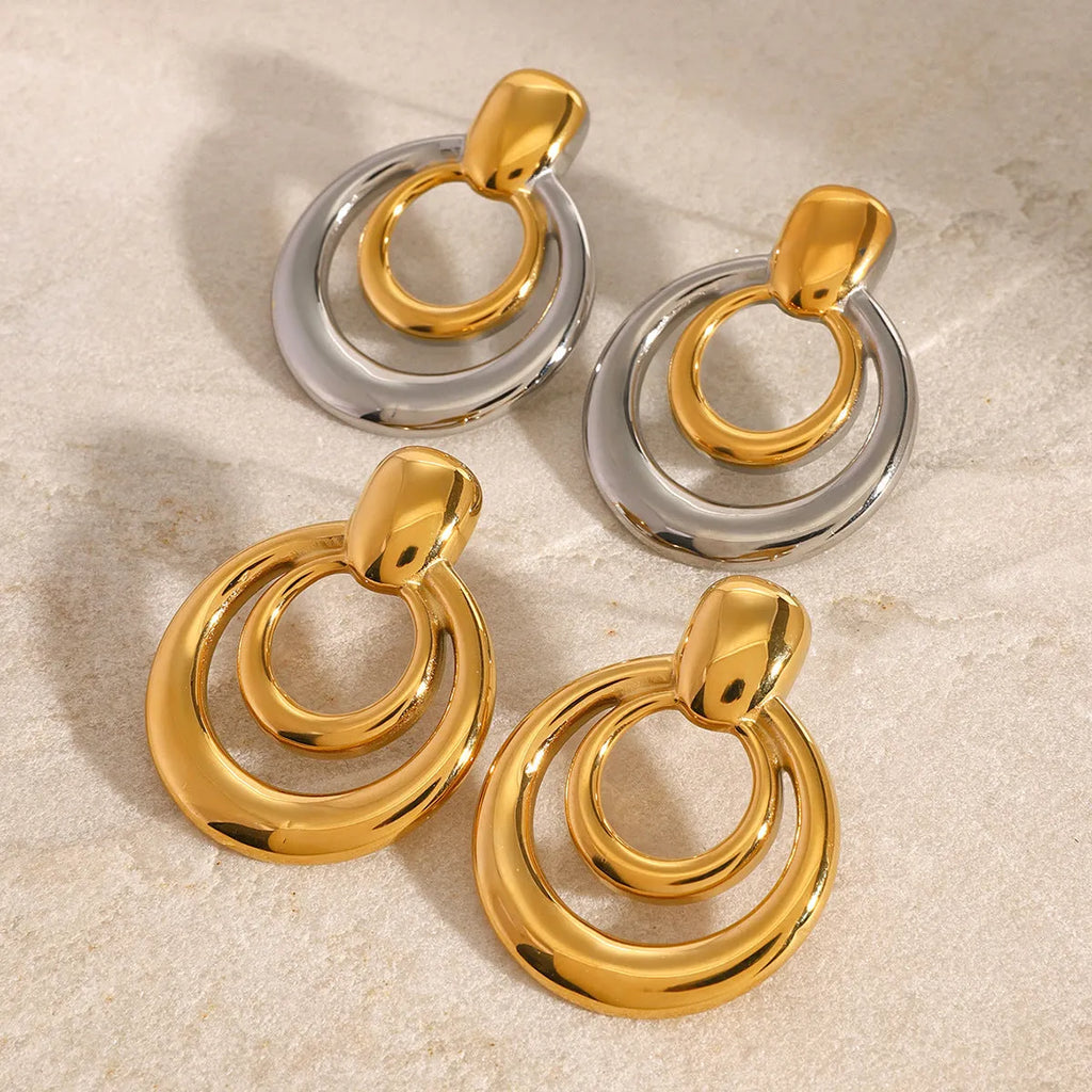 Golden round stud earrings with double-layer hollow construction and contemporary geometry design