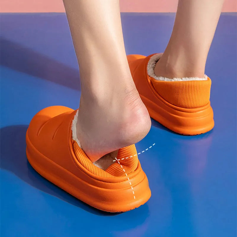A pair of waterproof EVA couple slippers with a warm plush lining, shown in a green colour option.