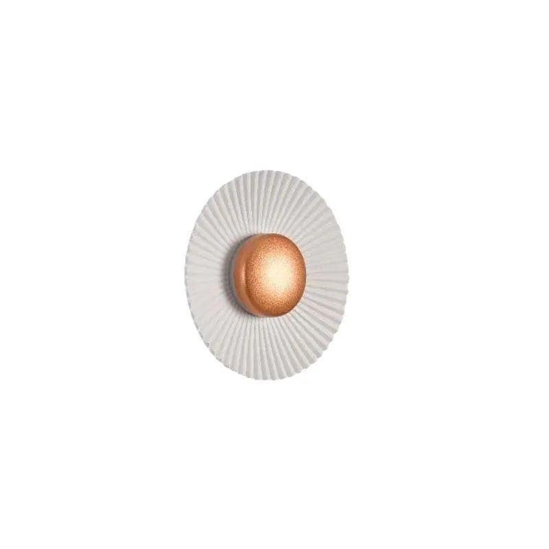 Round aluminium LED wall lamp in outer white and inner gold finish mounted on a wall.