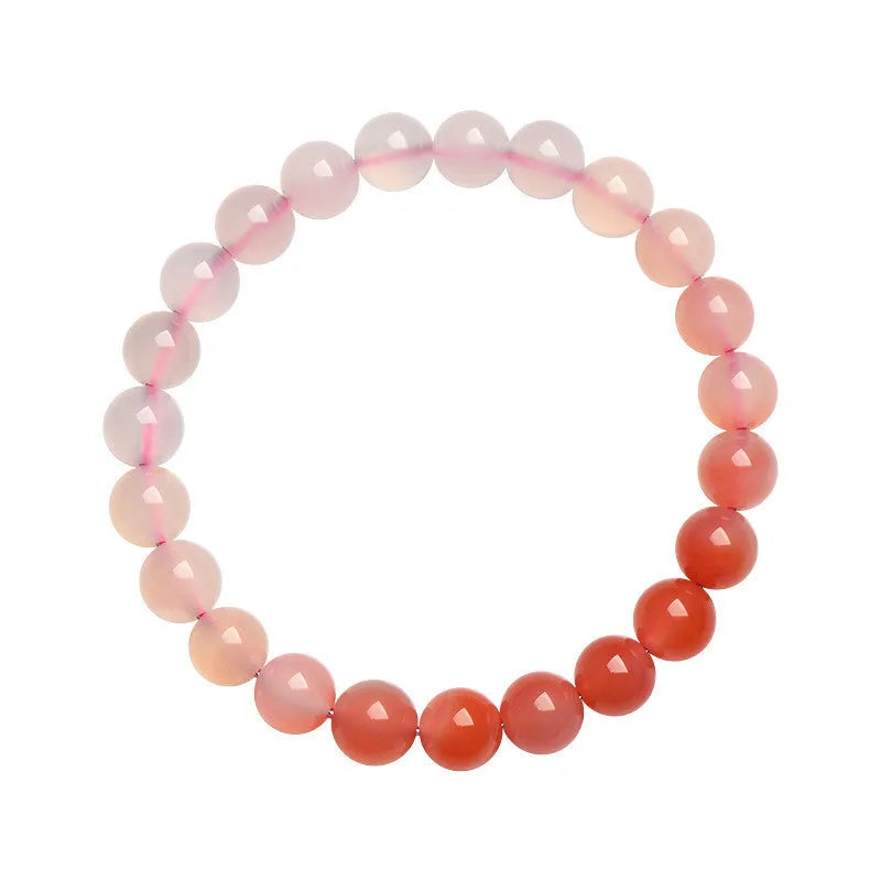 Natural gradient Yanyuan agate bracelet with geometric beads on a wrist, showing colour variation.