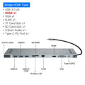 Grey aluminium ten-port USB hub docking station with cooling bracket on a desk.