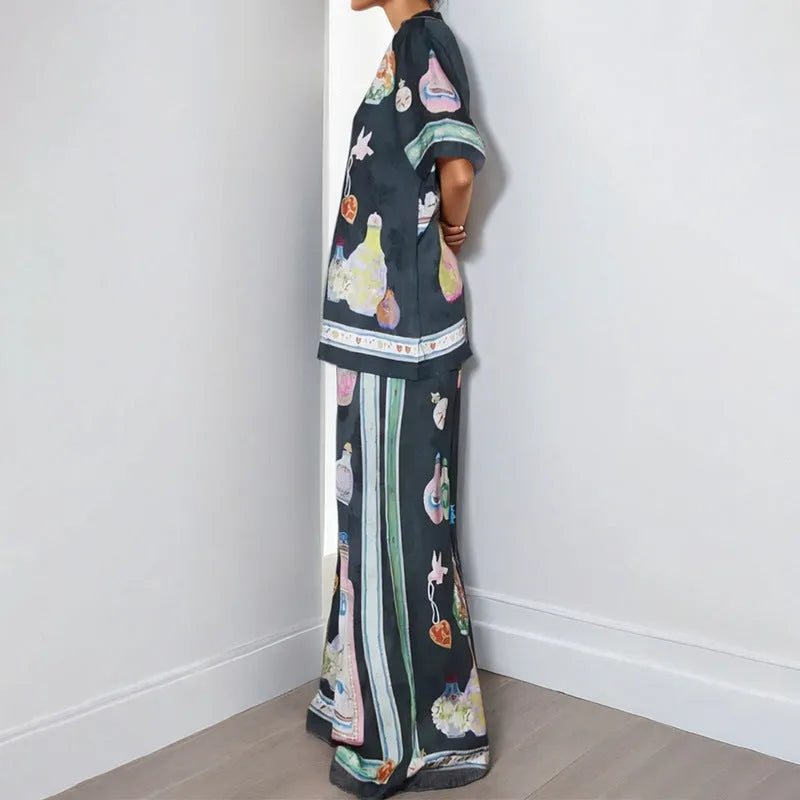 Women's black cardigan set with cartoon pattern, includes top and trousers
