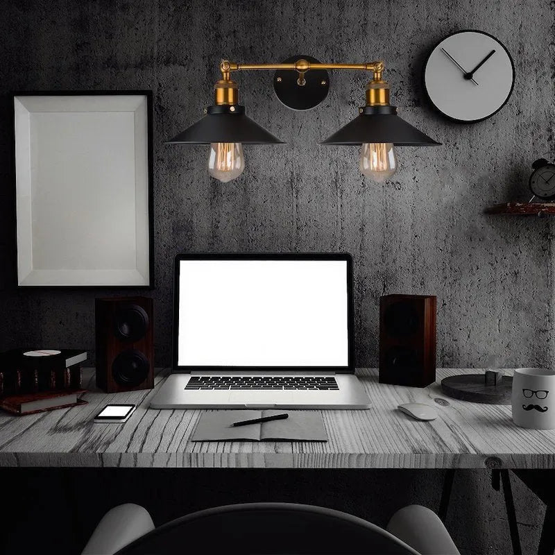 Black double head American retro industrial style iron wall lamp mounted on a wall.