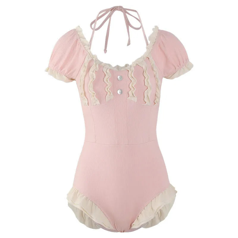 Pink women's one-piece swimsuit with conservative design on mannequin