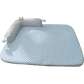 Blue pet bed cushion with big-eyed monster design for dogs and cats on a wooden floor.