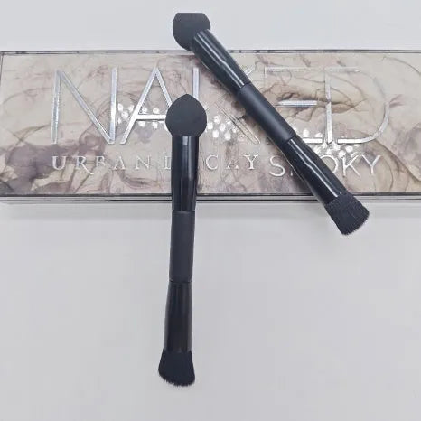 Elegant black double-headed makeup brush with a miter sponge and concealer brush on a wooden handle