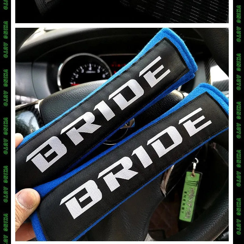 Pair of black car seat belt shoulder pad sleeves with embroidery detail, showing dimensions.