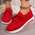 Women's low-top fly-knit style sneakers in black, blue, and red colours with round toe and lace-up front.