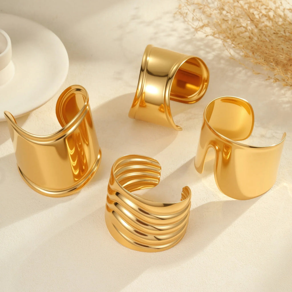 Gold plated stainless steel bracelet with exaggerated wide geometric wave design and asymmetric opening