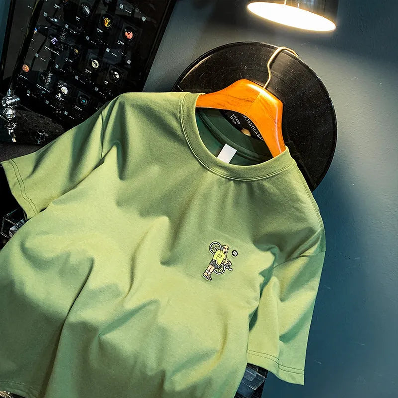 Green loose fit men's short sleeve t-shirt with a printed design on the front.