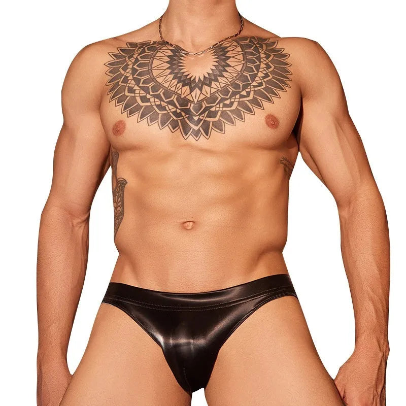 Men's black and white shark skin lace polyester briefs shown laid flat.