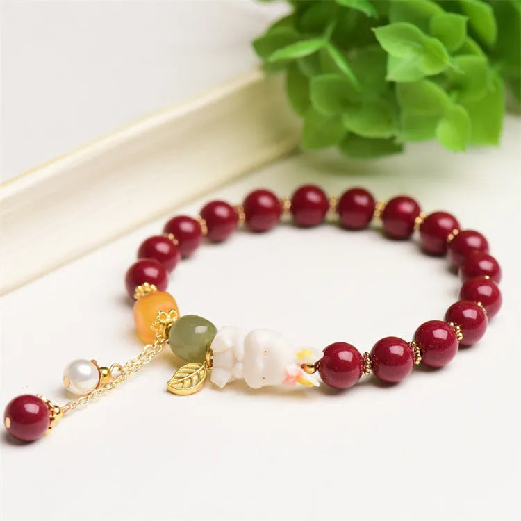 Natural cinnabar bracelet with rabbit charm for women, shown in 8mm and 10mm bead size options.