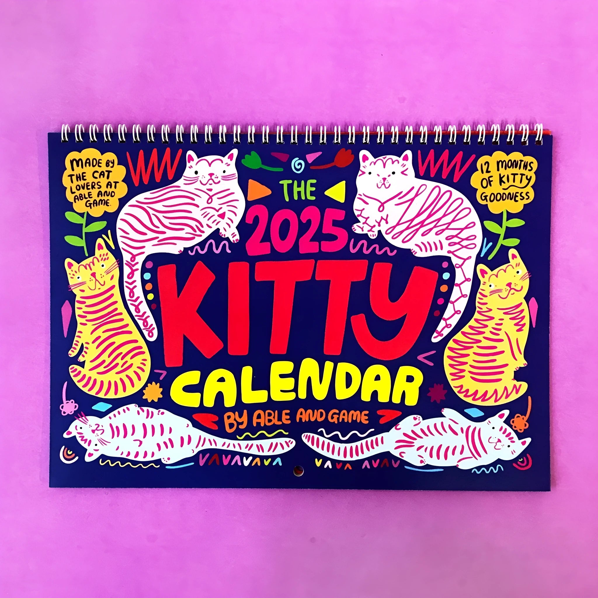 A cat-themed paper wall calendar for 2024 or 2025 displayed flat.