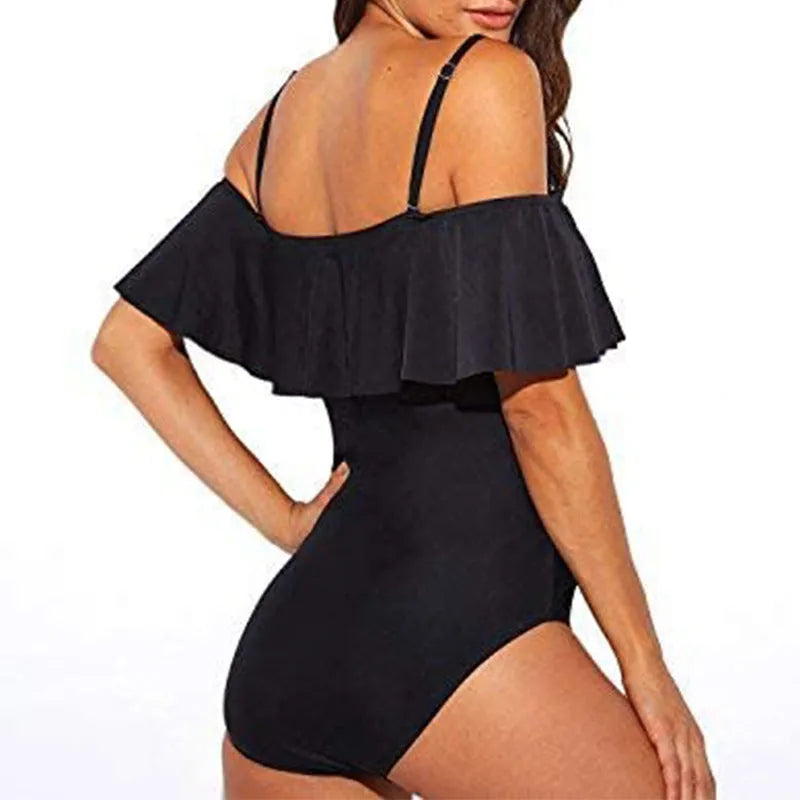 Black one-piece swimsuit with cut-out sides and ruffled shoulder straps on a mannequin.