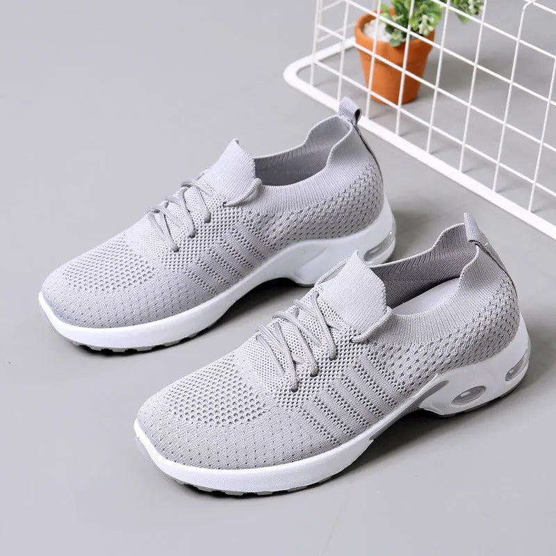 Women's black mesh casual sneaker with a round toe and white non-slip PVC sole on a light background.