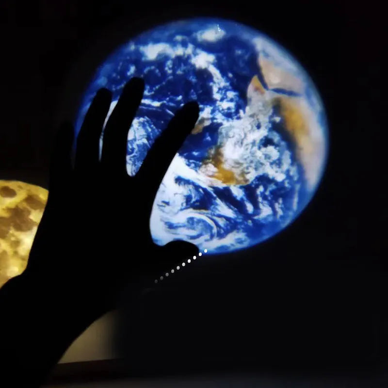 USB-powered Earth and Moon projection lamp with flexible hose bracket on a wooden table.