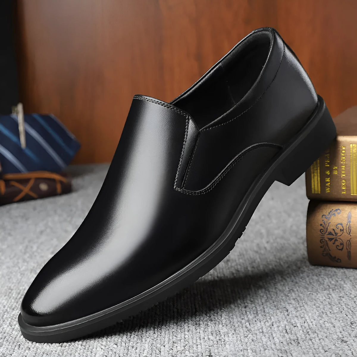 Men's black genuine leather slip-on loafers with a rubber sole and leather toe cap.