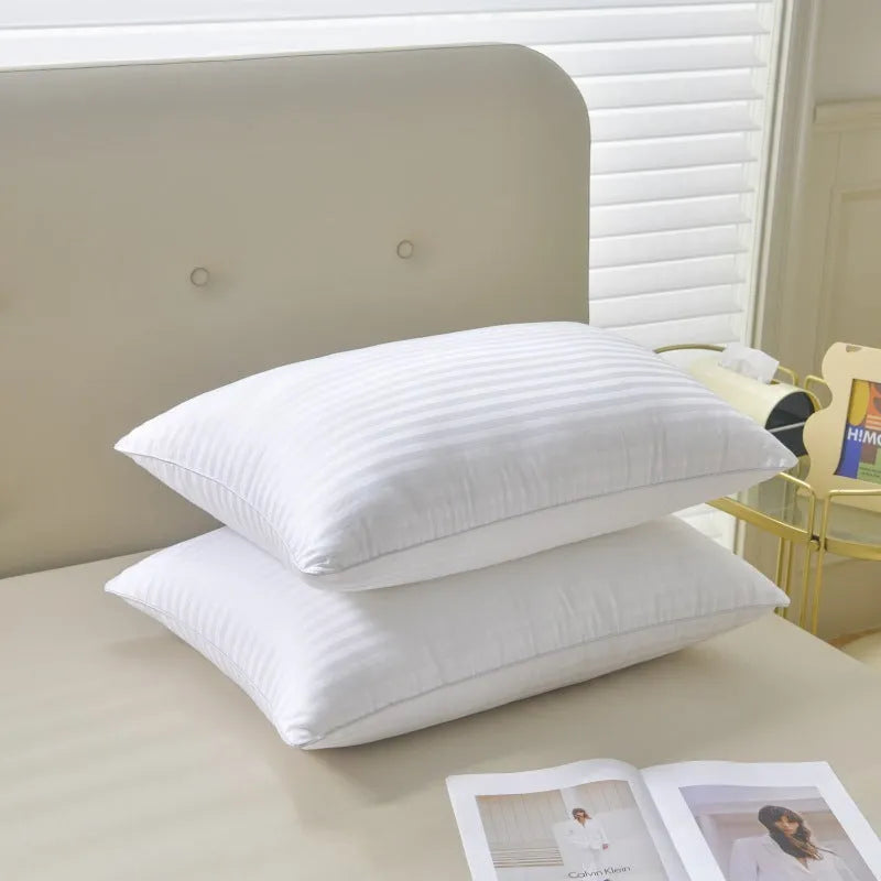 White cotton pillow with satin stripe pattern showing feather and cotton fill in three available sizes