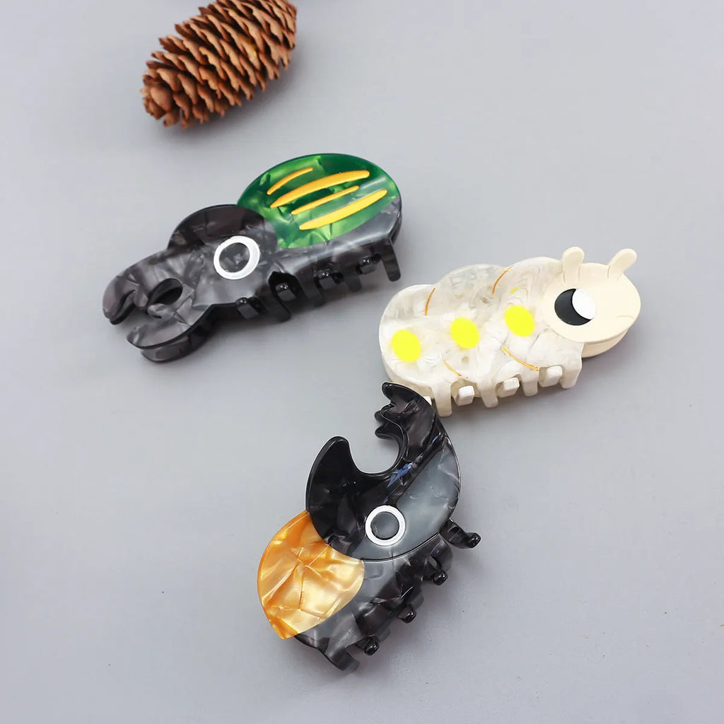 Handmade cellulose acetate beetle grip accessory in green, orange or white insect biology colours