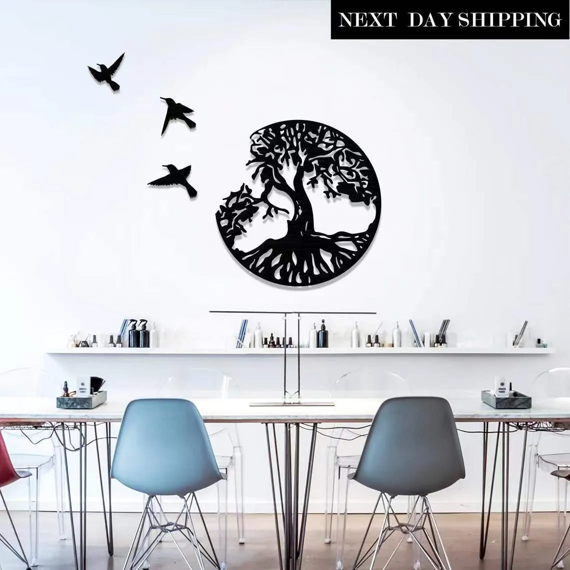 Black modern iron wall hanging with electroplated finish and hanging strap.