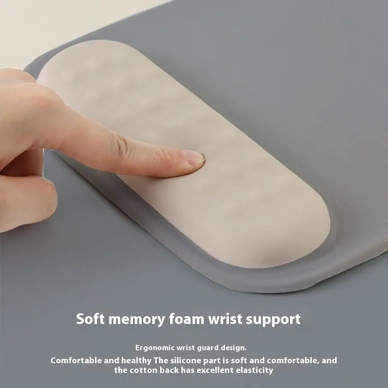 Ergonomic cloth-silicone mouse pad with raised wrist support on a desk