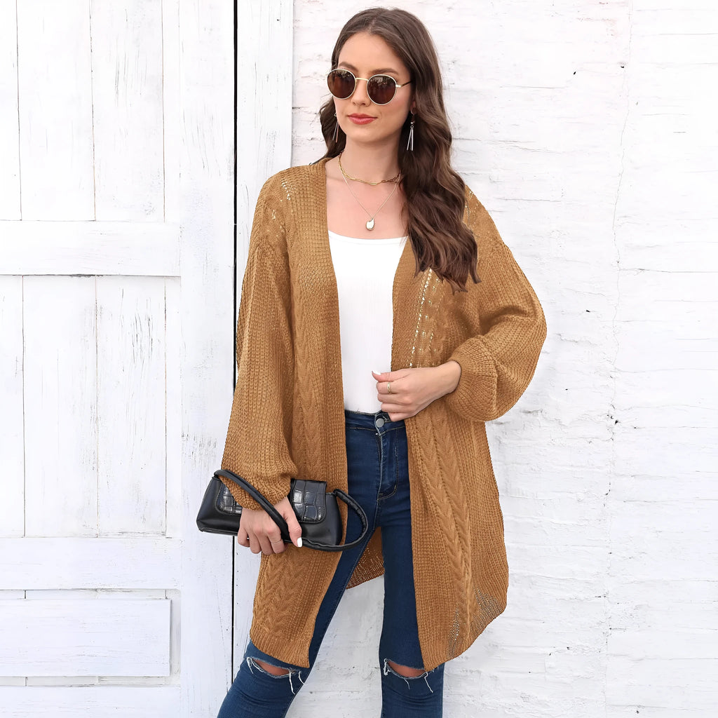 Women's loose-fitting long sleeve acrylic sweater coat in a solid colour on a hanger.