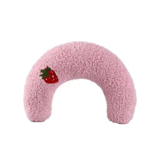 Small blue half-donut shaped pet pillow bed for cats or small dogs on a carpet.