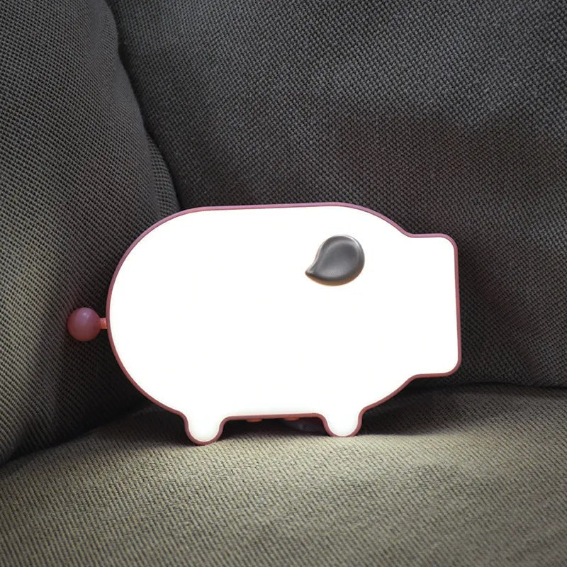 Blue multifunctional LED alarm clock displaying time and temperature on bedside table with USB cable.