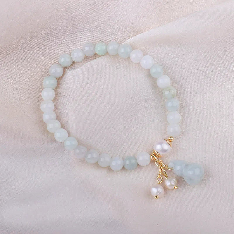 Natural jade bracelet with hand-carved gourd design in Chinese women's style.