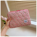 Printed cloth laptop bag for women shown in floral and heart patterns, available in small, medium, and large sizes.