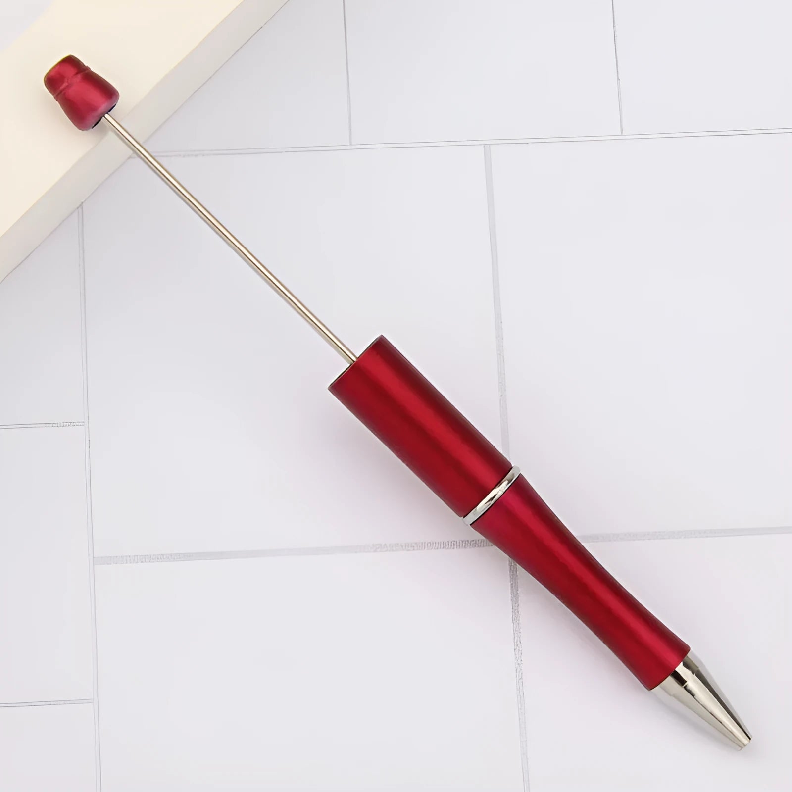 Ballpoint pen with colourful spinning plastic beads on barrel, shown in a gradient purple finish.