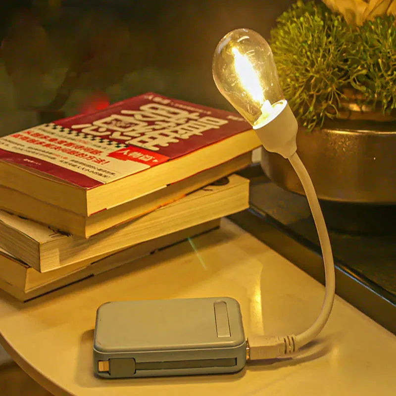 USB rechargeable folding tungsten filament night light in extended position showing warm white illumination
