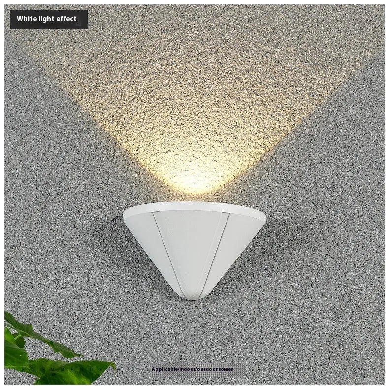 Black bird's nest design LED courtyard lamp with IP65 waterproof rating on a garden wall.