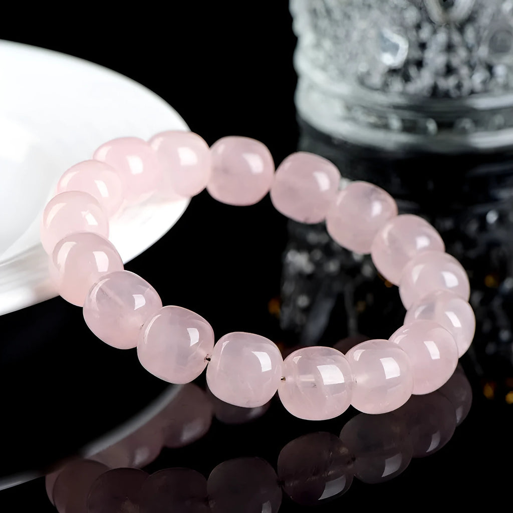 Pink crystal geometric barrel bead bracelet with 11-12mm beads on a wrist.