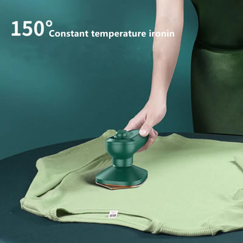 Dark green hand-held steam iron with ceramic panel showing dual temperature buttons and compact design