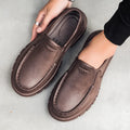 Men's black slip-on casual shoes with a round toe and chunky waterproof platform sole.