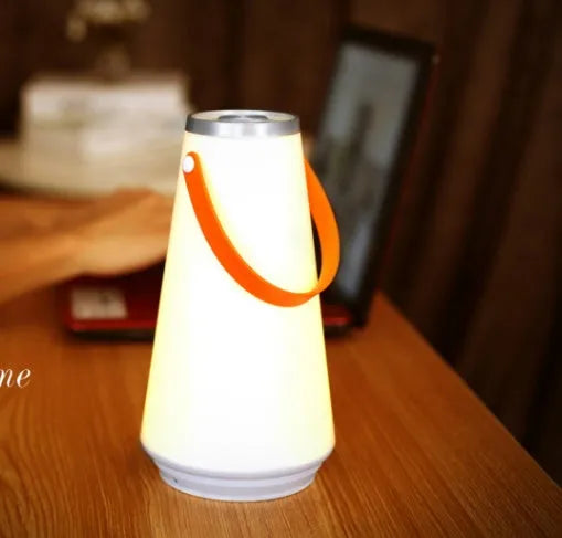 White rechargeable LED bedside lamp with square base measuring 12cm, showing warm white illumination from six LED beads