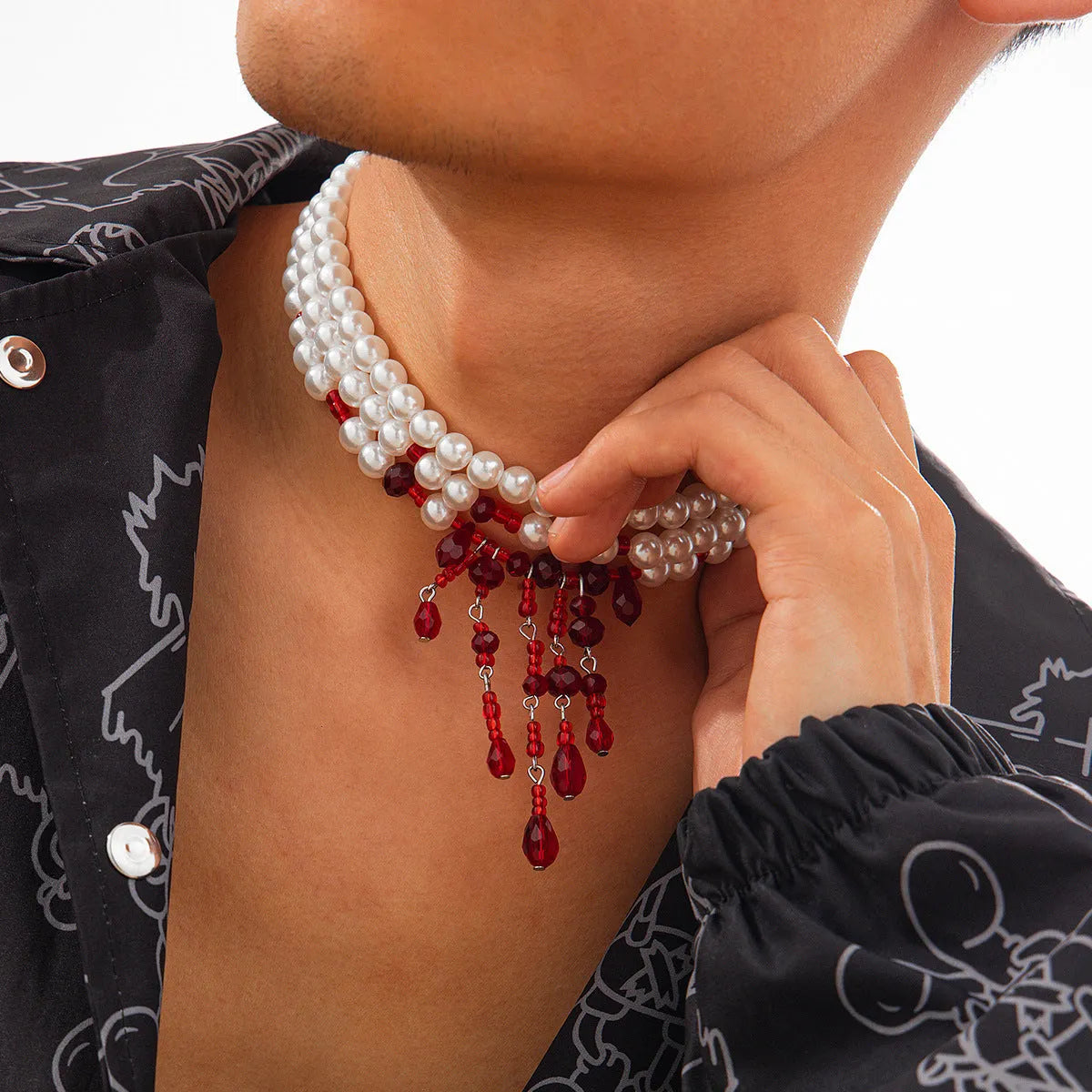 Men's Halloween necklace with red artificial crystal blood drop pendant and black imitation pearl tassels on a metal chain.