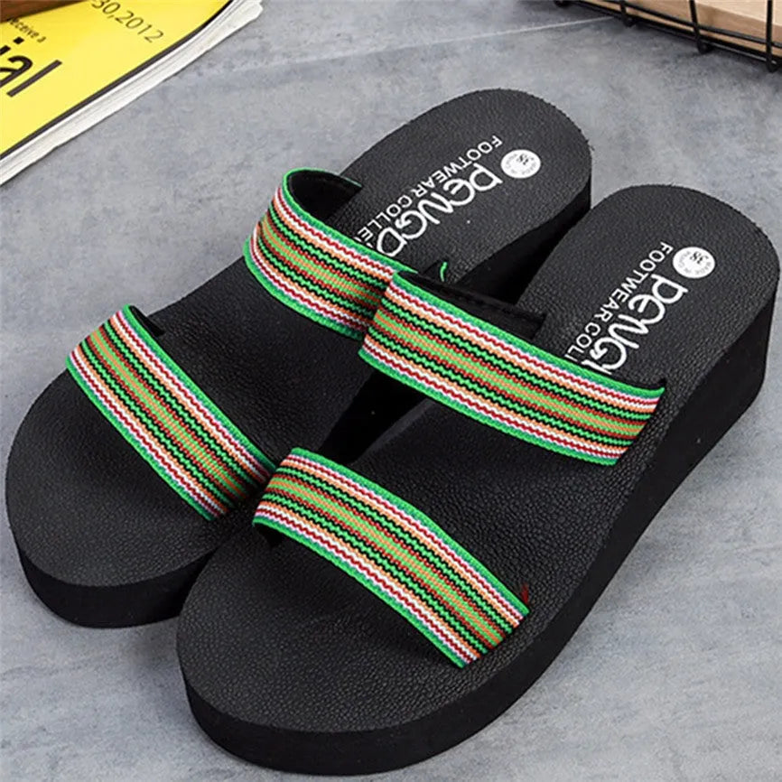 Brown women's bohemian summer slippers with elastic strap on a wooden floor.