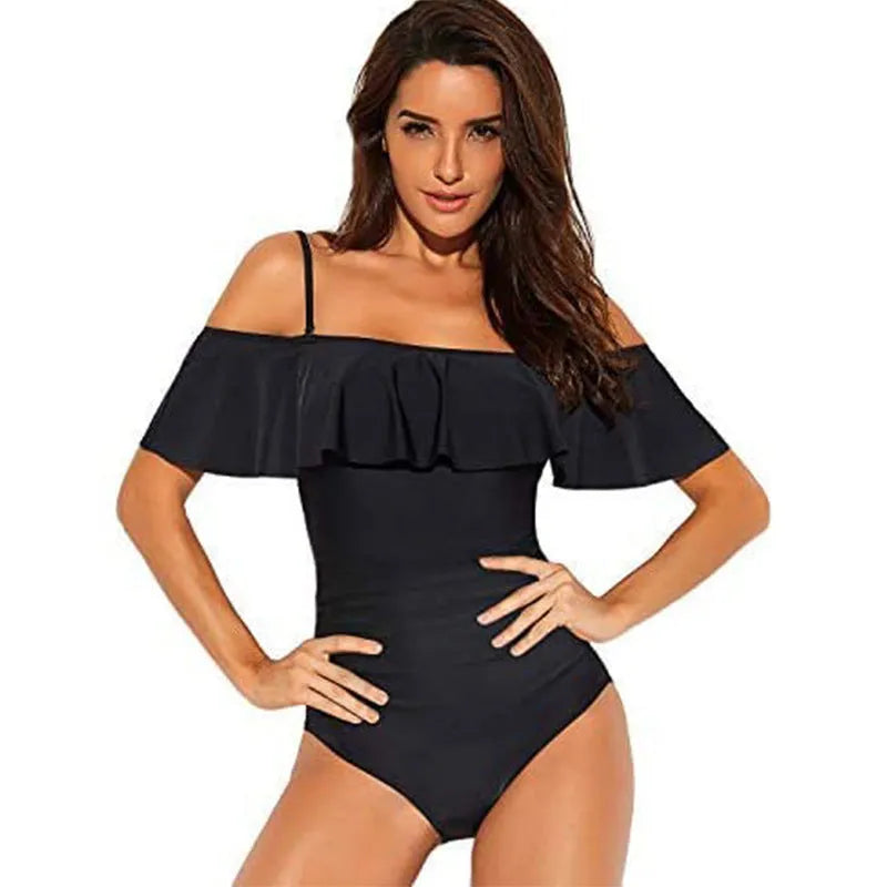 Black one-piece swimsuit with cut-out sides and ruffled shoulder straps on a mannequin.