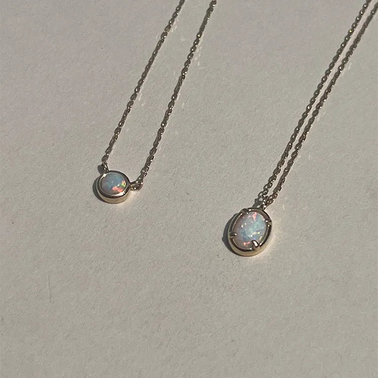 Jelly opal gemstone set in a geometric oval sterling silver pendant necklace.
