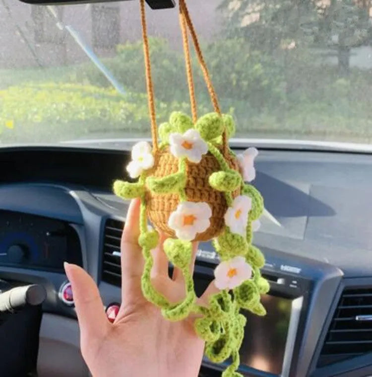 Green and white knitted wool car plant decoration with plastic base and hanging rope