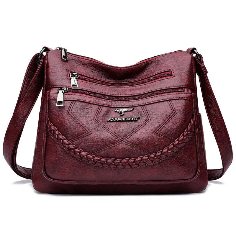 Soft PU leather crossbody shoulder bag in a horizontal square shape, shown in one of four colours: black, blue, red, or yellow.