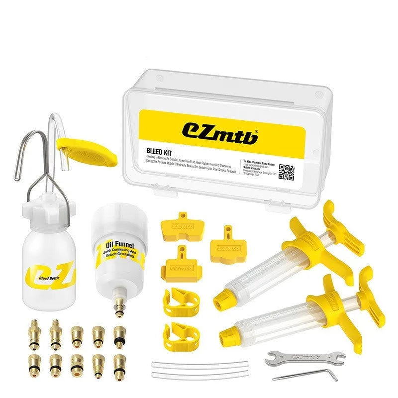 EZmtb bicycle hydraulic disc brake bleed kit with syringes, adapters, and tools on a workbench