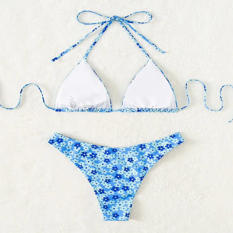 Women's blue floral print two-piece swimsuit with lace-up front and side-split shorts