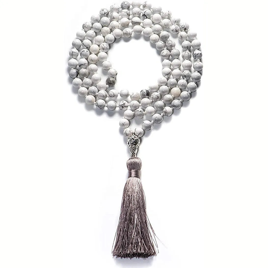 Long beaded agate necklace with geometric stones and a tassel, showing colourful variations.