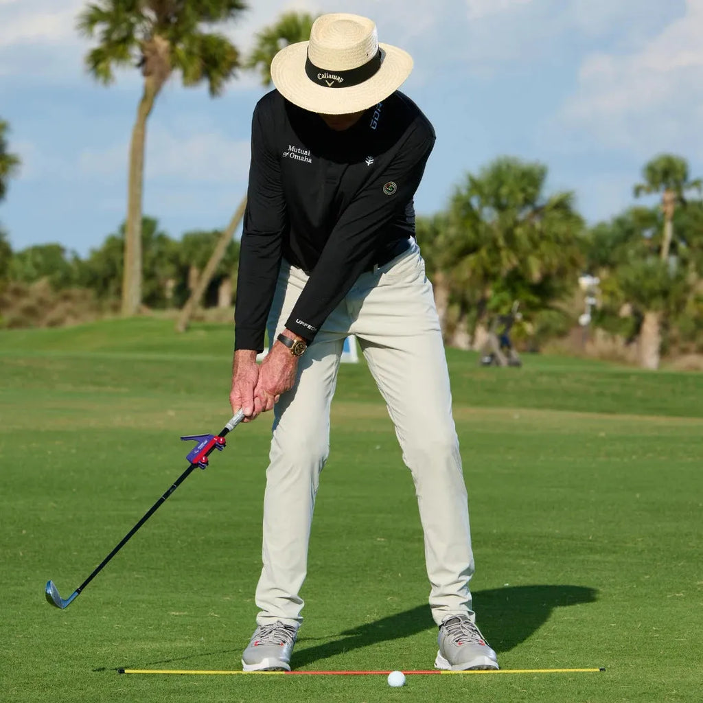 Plastic golf swing plane training aid shown on a solid background.